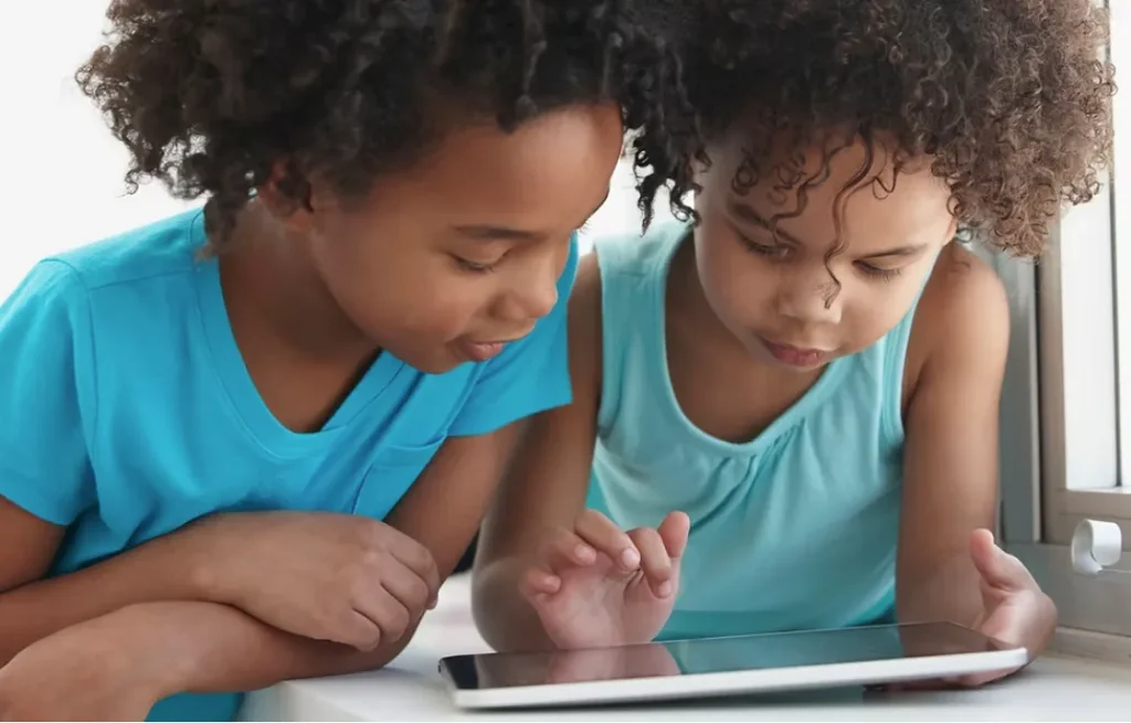 Two kids reading a book